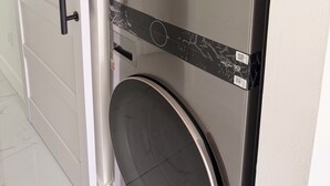 A modern kitchen with a stainless steel refrigerator, a microwave, and a dishwasher. - Beautiful house near marlins stadium (Miami)