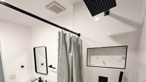 A modern bathroom with a shower, toilet, sink, and mirror. - Beautiful house near marlins stadium (Miami)