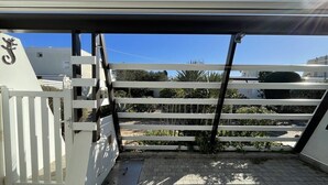 A gated entrance with a metal gate, a white fence, and a paved pathway leading to a building. - VILLA SAVANNAH - Villa Port Nature 105 - Luxury - 4 people (AGDE)