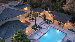 A residential property with a swimming pool, outdoor seating areas, and multiple buildings. - El Pomar Estate - Main House by Avantstay Pool + Hot Tub + Firepit + Outdoor Dining + Vineyard Views (Templeton)