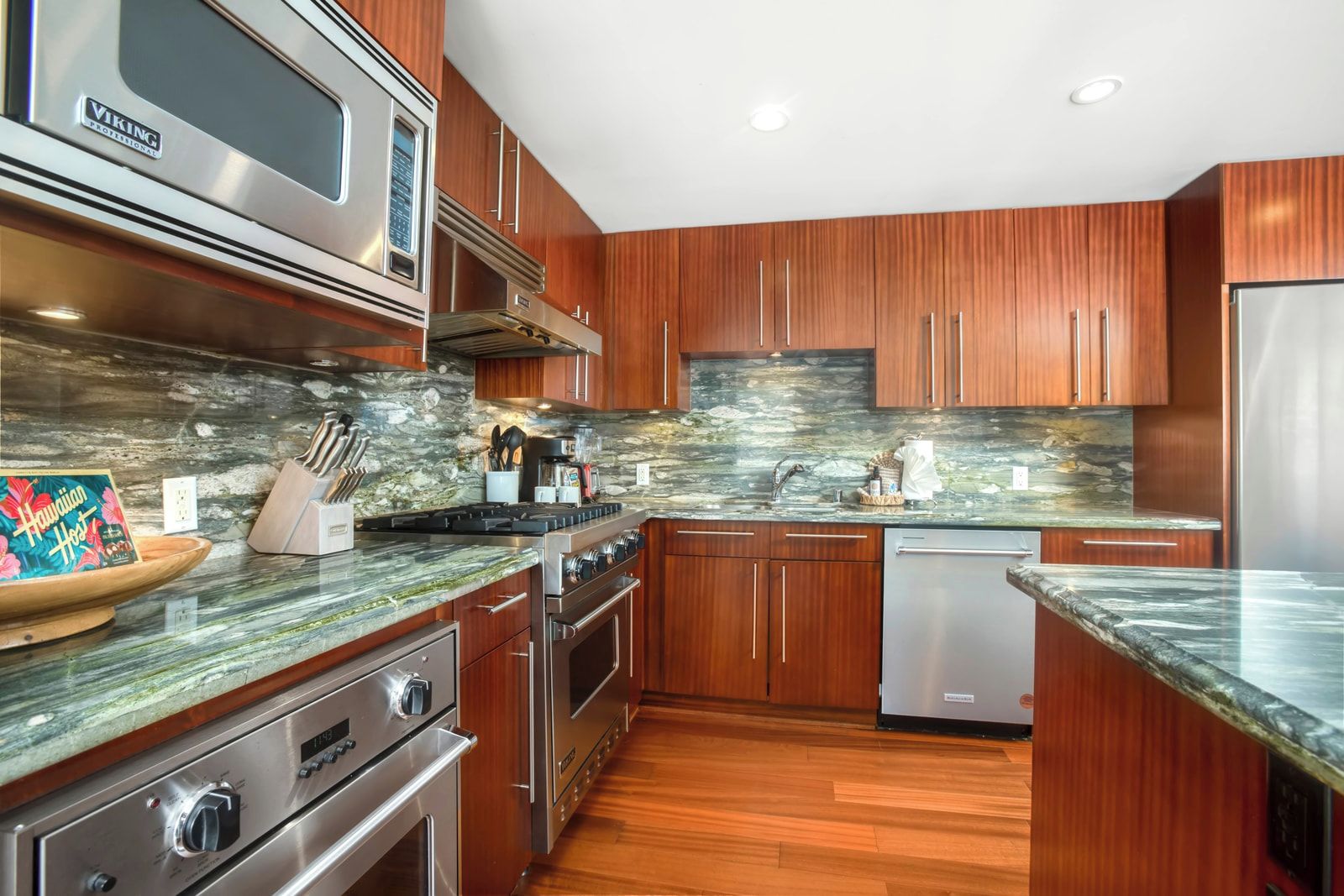 A modern kitchen with wooden cabinets, a stainless steel range, a microwave, and a dishwasher.