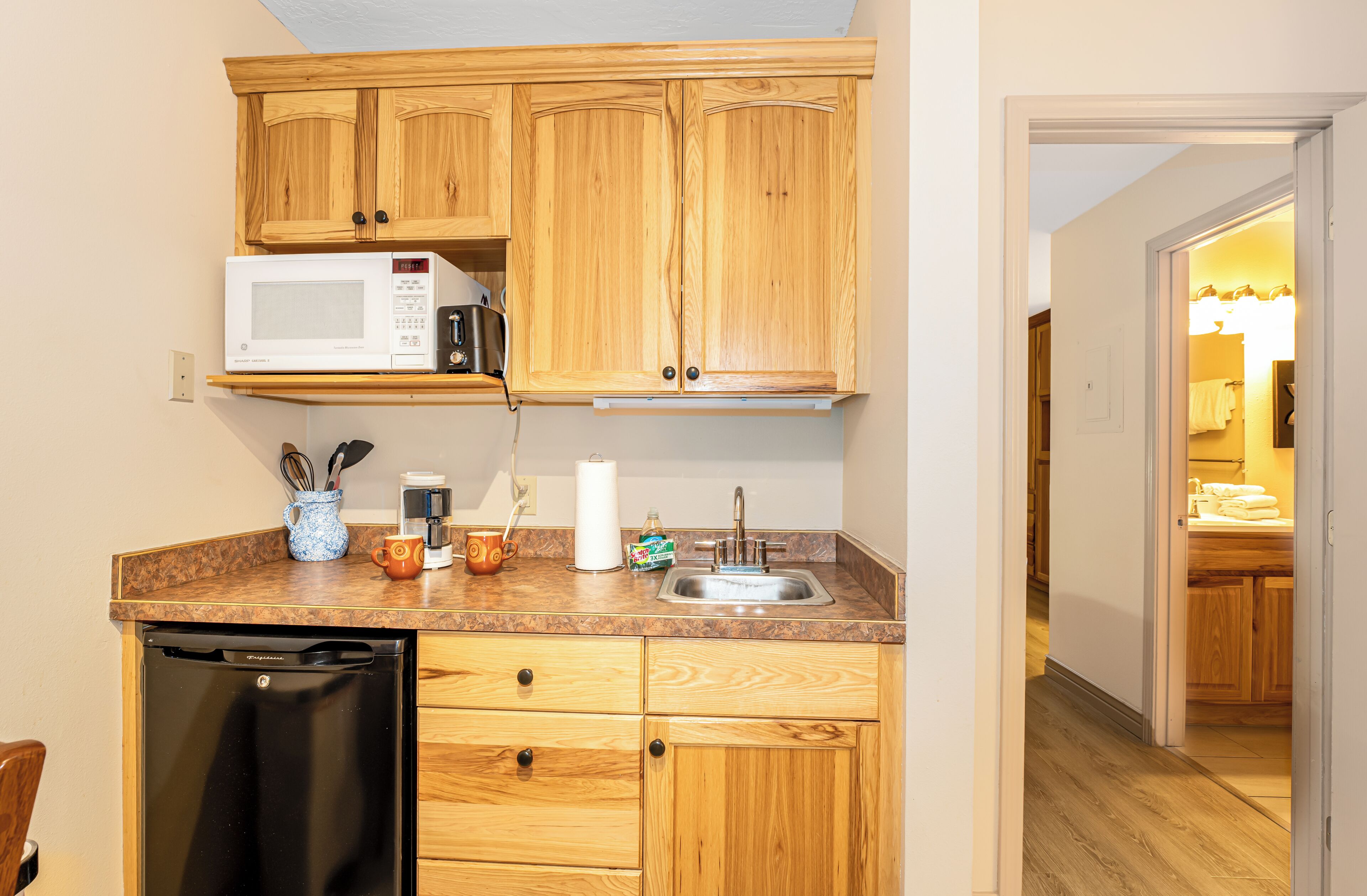 Fridge, microwave, coffee/tea maker, cookware/dishes/utensils