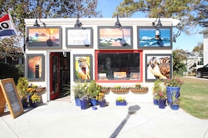 An art gallery with framed artworks and potted plants. - Stunning and Gorgeous with Comm Pool, Tennis, Pickleball, Bikes, Free Activities Inc Golf @ Bear Tra (Rehoboth Beach)