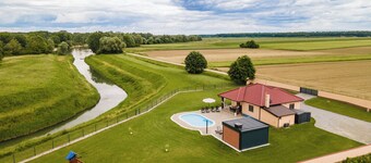 Riverside retreat with pool, summer kitchen, playground, and peaceful Drava views.