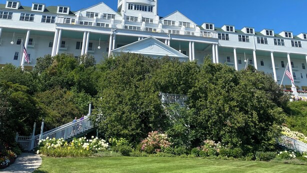 A large white building with a central tower, multiple windows, and a flag. - Cheboygan Michigan Escape – River Views & Adventure Nearby.  (Cheboygan)