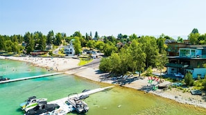 A coastal area with a beach, swimming pool, and boats.
