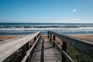 A wooden boardwalk leading to a beach with waves. - New Listing! Direct Oceanfront 2/2 | Huge Private Balcony | Beachfront Pool | Garage (Ormond Beach)