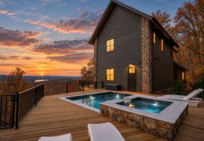 Une maison à deux étages avec une piscine et des chaises longues.