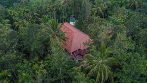 A house surrounded by dense tropical vegetation. - Orchid Trails Resort Wayanad by Zeebull (Sulthan Bathery)