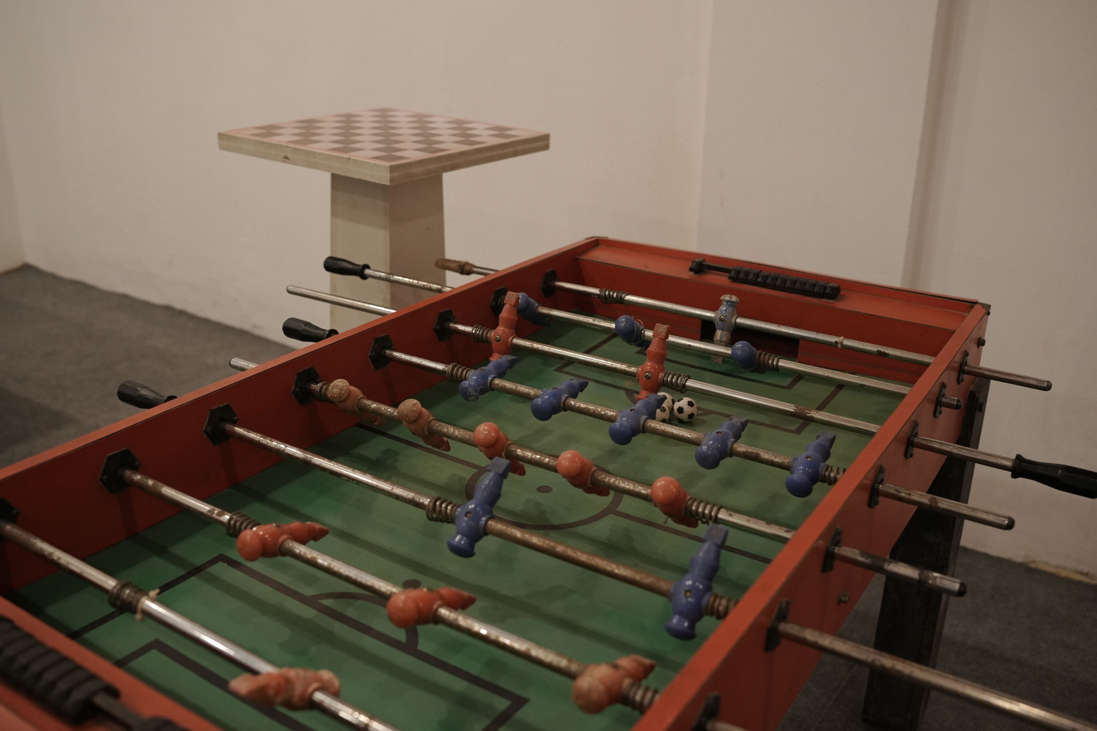 A foosball table with a checkered table in the background.