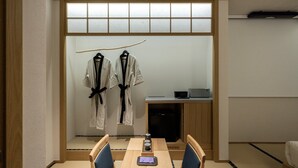 A traditional Japanese room with tatami flooring, a low table with a tea set, and a TV on a wooden cabinet. - Anook Ryokan Hotel Eunpyeong Bulgwang (Seoul)
