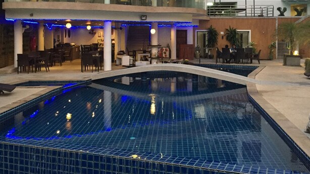 A hotel with a swimming pool, outdoor seating, and a glass-enclosed lounge area. - Patong Beach Walking Street Seaview C257 (Patong)
