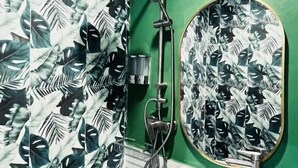 A bathroom with a shower, a sink, and a mirror. - Midori Rawai (Rawai)