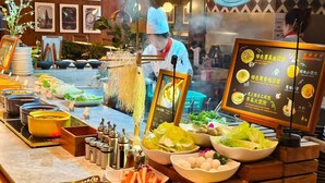 A buffet setup with various food items and condiments. - Intercity Shanghai Xujiahui (Shanghai)