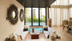 A modern living room with a pool, white sofas, and a wooden coffee table. - Trobbu (Tulum)