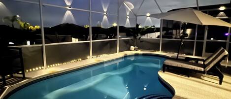 An indoor swimming pool with a covered area and lounge chairs.