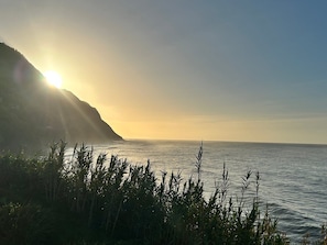 A coastal landscape with a mountain, ocean, and vegetation. - Alma do Mar - Soul of the Sea (Povoação)