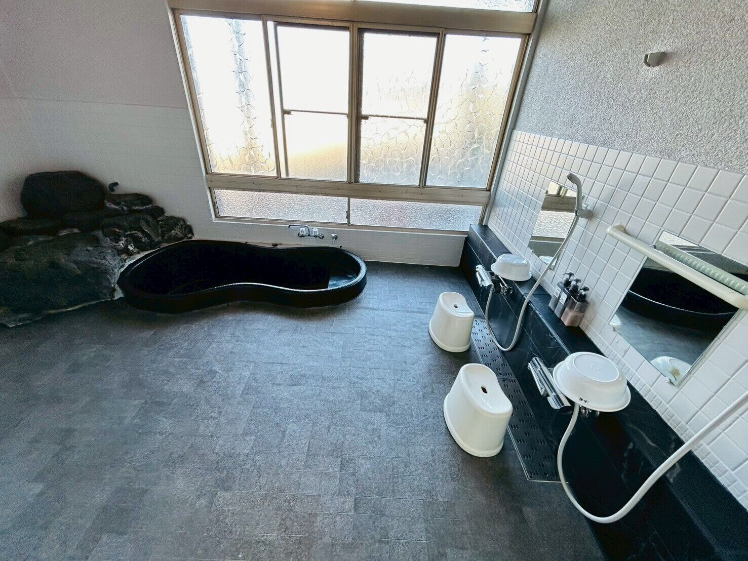 A bathroom with a bathtub, a toilet, and a sink.
