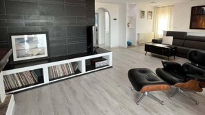 A modern living room with a black fireplace, a sofa, and a coffee table. - Beautiful house with a swimming pool and views in Roses AV/33 (Roses)