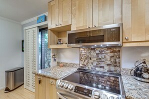 A kitchen with a stainless steel stove, microwave, and a tiled backsplash. - 2 Mi to Dtwn! Snowbird Gem w/ Pool in Palm Springs (Palm Springs)