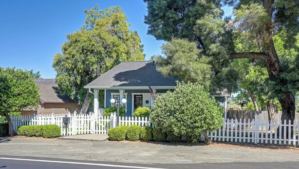 A residential house with a front porch, a picket fence, and a driveway. - Remodeled Historic Folsom Craftsman House - Pool - Walk to Sutter St (Folsom)
