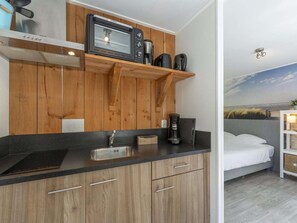 A compact kitchen with a microwave, coffee maker, and a small sink. - Holiday Home Near Dutch Beach With Pool (Sint Maartensvlotbrug)