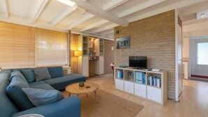 A modern living room with a sofa, coffee table, and entertainment unit. - Wildrijk 152 Holiday Home in Sint Maartenszee (Sint Maartensvlotbrug)