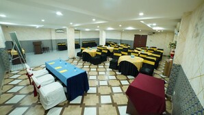 A conference room with multiple tables, chairs, and a stage area. - Hotel V Platina  (Bhubaneshwar)