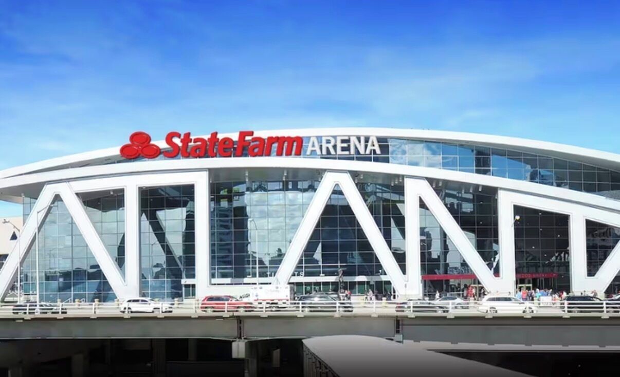 A modern building with a large glass facade and the text 'StateFarm Arena' on the top.