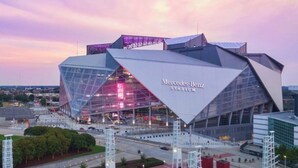 A modern stadium with a distinctive angular design, labeled 'Mercedes-Benz Stadium.' - Welcome to your fun 2BR/2BA arcade loft—relax, play, and enjoy your stay!! (Atlanta)