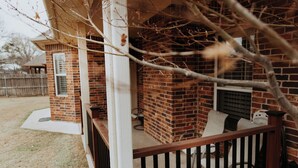 A brick exterior with a wooden deck, a small brick structure, and a chimney. - Sleek Ardmore Home, near lake Murray, Mercy Hospital, Lakecrest, Winstar casinos (Ardmore)