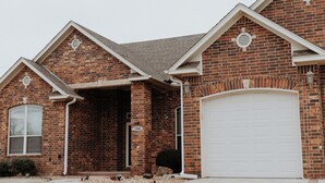 A brick house with a garage, a visible number '1306' on the door, and a small porch area. - Sleek Ardmore Home, near lake Murray, Mercy Hospital, Lakecrest, Winstar casinos (Ardmore)