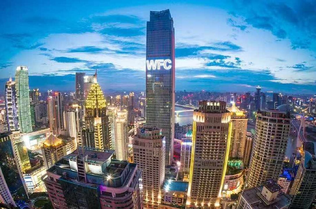 A cityscape with a prominent skyscraper labeled 'WFC' at dusk.