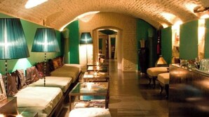 A hotel lobby with a high arched ceiling, a sofa, a coffee table, a bar area, and a round ottoman. - Vienna ROOF TOP Terrace APT (Wien)