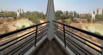 Balcony Deluxe Room with Washroom & Workstation inside a 4BHK Apartment