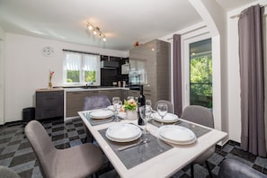 A modern kitchen with a dining area set for four.