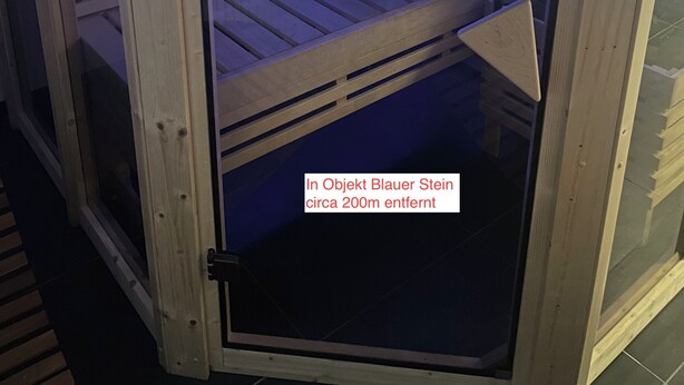 A sauna with a wooden interior and a glass door, featuring a blue light strip along the benches. - Spacious, Comfortable Apartments in a Quiet Setting Near Cologne (Pulheim)