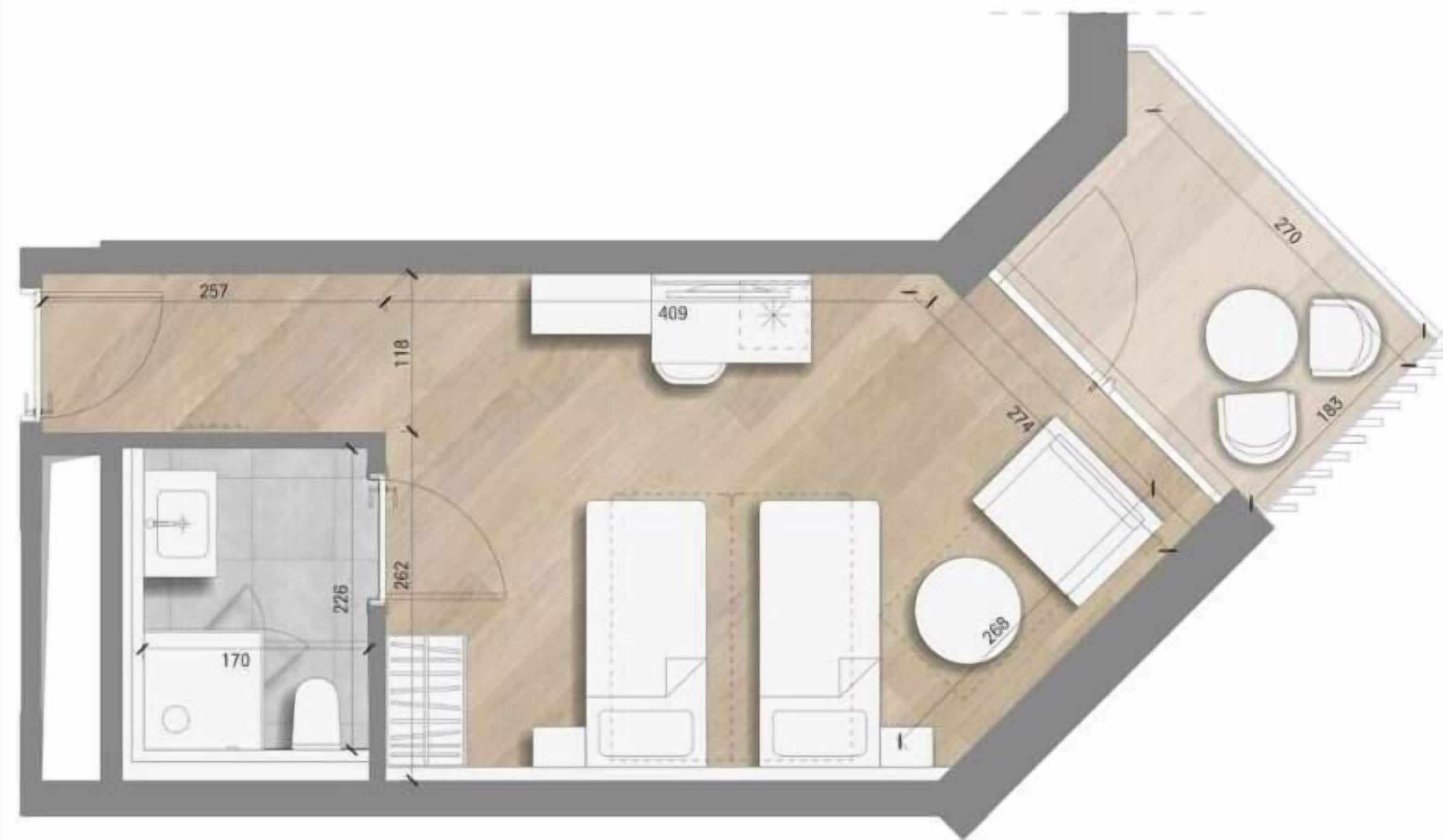 A floor plan of a hotel room with a bathroom, a small kitchen area, a seating area, and a circular seating space.