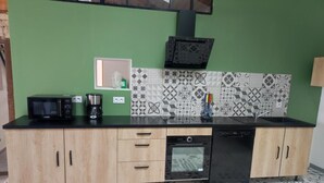 A kitchen with a microwave, coffee maker, and dishwasher.