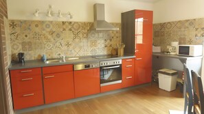 A kitchen with a stove, oven, microwave, and a sink. - Holiday Apartment for 2 People (45 m²) in Eggesin (Eggesin)