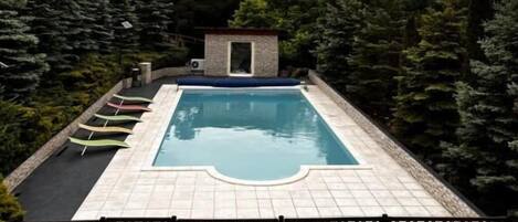 Seasonal outdoor pool, open 9:00 AM to 8:00 PM, pool umbrellas