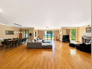A spacious living area with a dining table, sofas, and a TV. - Superb Contemporary Luxury Holiday Villa Rental in - Afandou - sleeps 10 guests (Afantou)