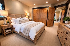 A bedroom with a wooden bed, nightstands, a dresser, and a wardrobe. - Main Street | 4BD ALL Ensuite | Hot Tub (Park City)
