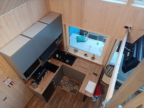 A compact kitchen with a window, a small dining area, and a visible stove. - Domek nr 4 "błękitne Wzgórze" (gmina Brzuze)