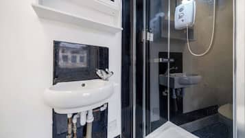 Shower, hair dryer, towels, shampoo