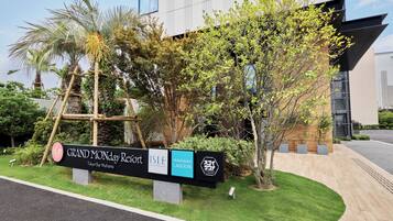 A signboard for Grand Monday Resort with Isle Pool Club Restaurant and Maihama Lagoon.