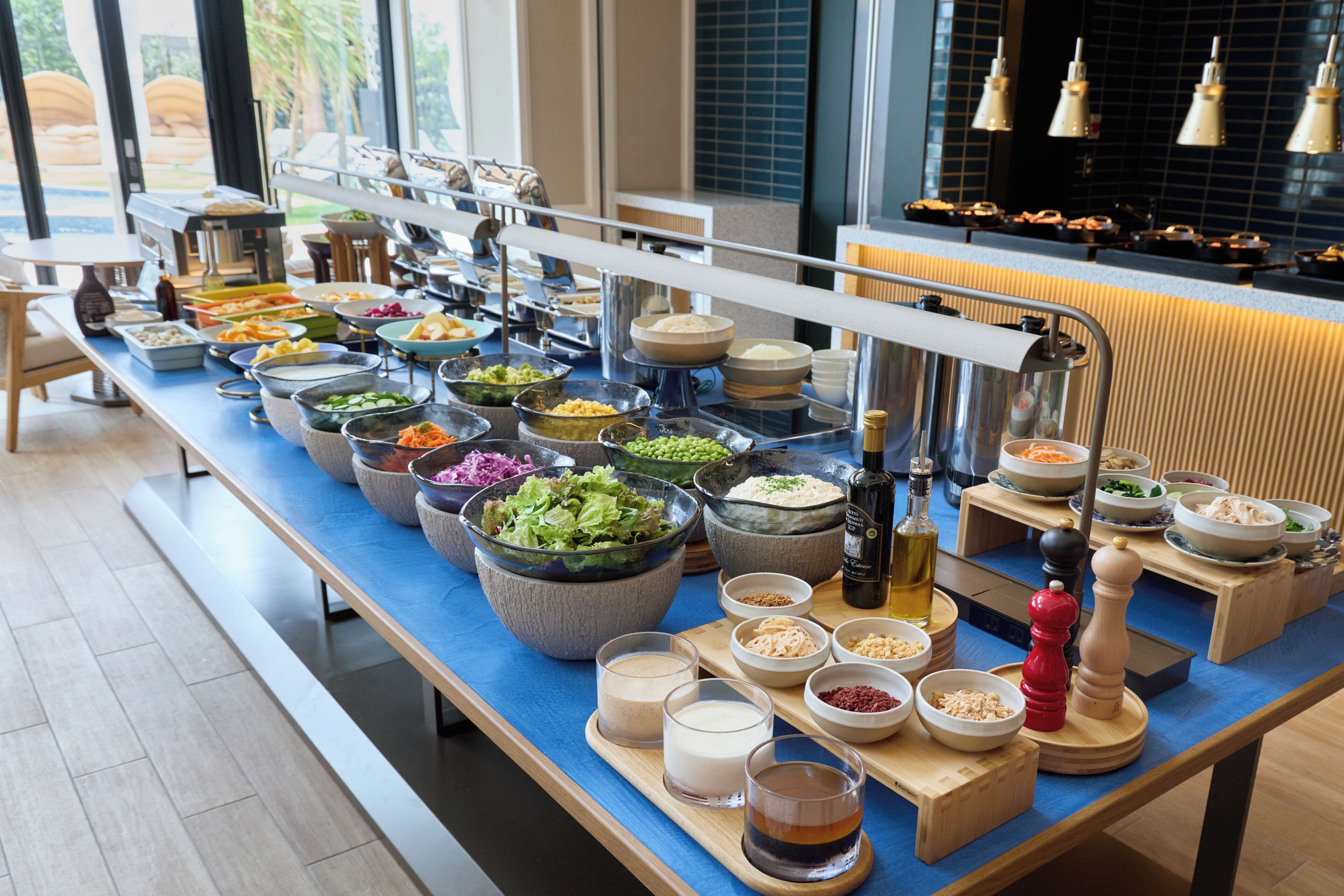 A buffet setup with various food items and condiments.
