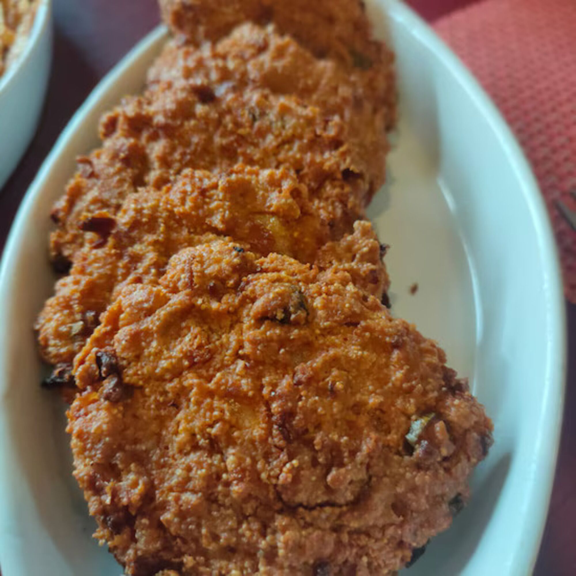 A white plate with a crumbly, textured food item.