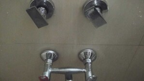 A bathroom with a shower head, a faucet, and a toilet. - Raj Residency Govindpuri (New Delhi)