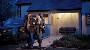 A house with a garage, a driveway, and a bench outside. - Roxburghe Cottages, Part of Destination by Hyatt (Kelso)